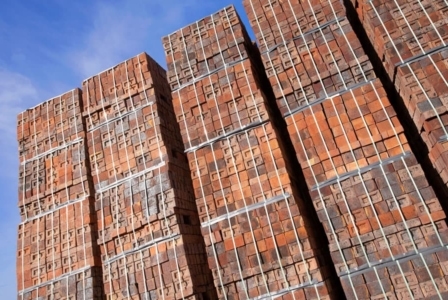 photo of large stacks of red bricks